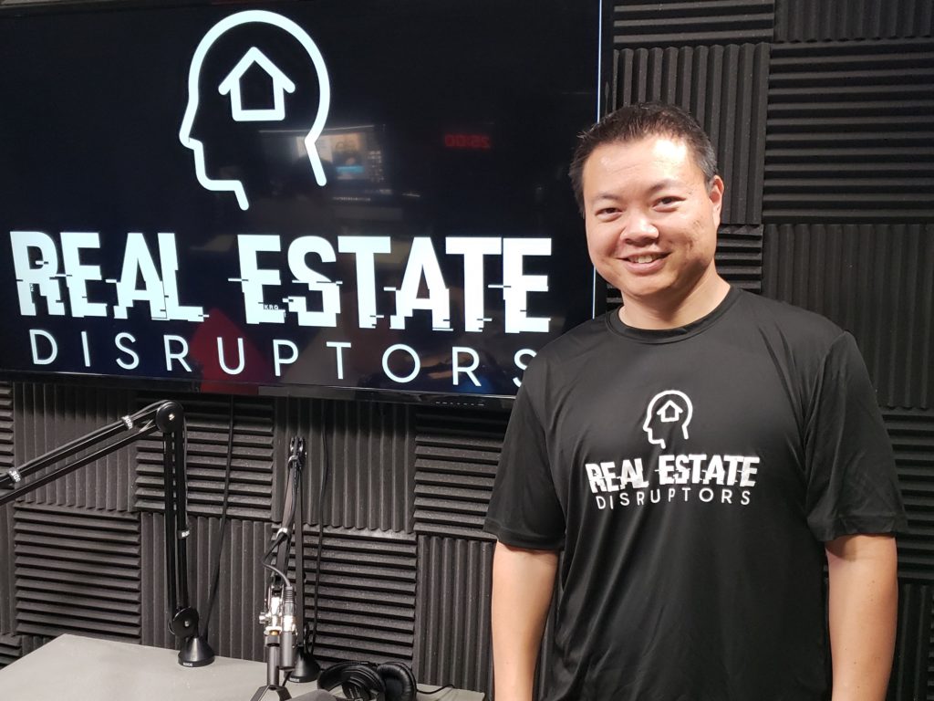 Photo of Steve Trang with Real Estate Disruptors podcast backdrop